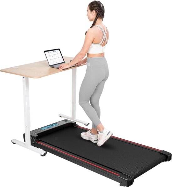 we can see a modern and stylish treadmill with desk. speed, time, distance, The user is walking on the treadmill while working on a loatop. The treadmill is placed at work station creating a pleasant and stimulating atmosphere for exercise.
